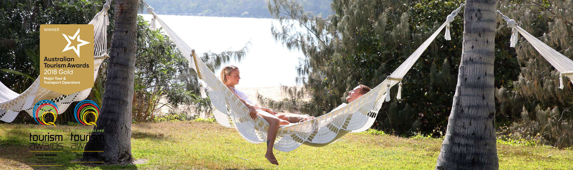 paradise-cove-resort-whitsundays-header-and-awards a man holding a frisbee