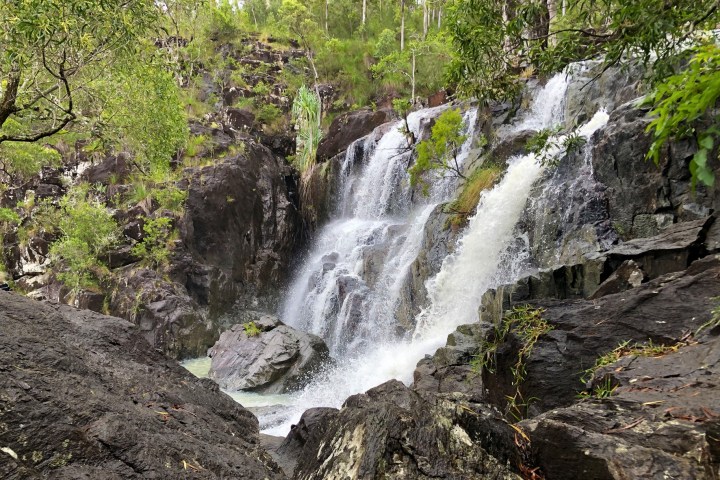 a large waterfall over a rocky cliff