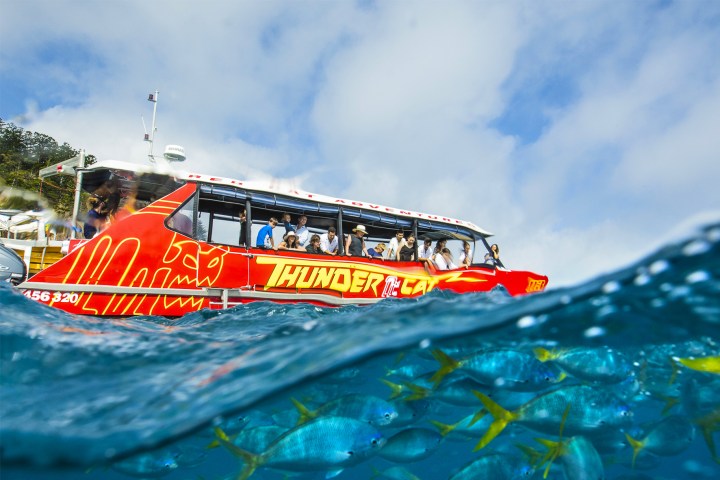 an orange boat on a body of water