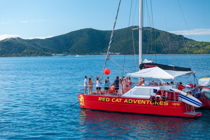 People on a red catamaran named Tongarra out the front of Hayman Island
