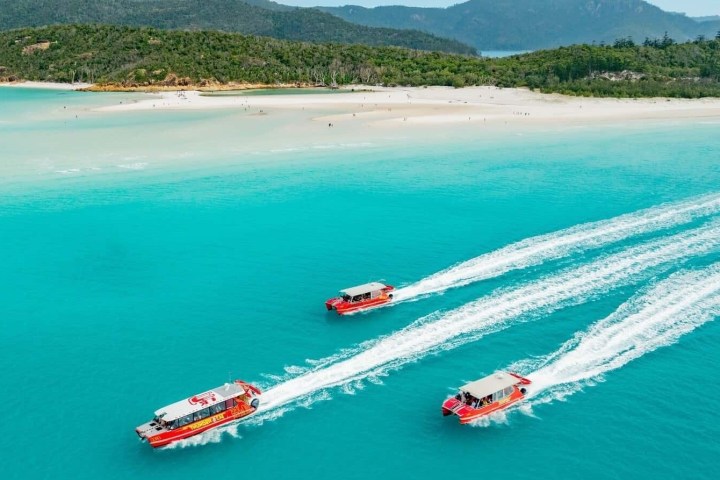 a body of water with a mountain in the ocean