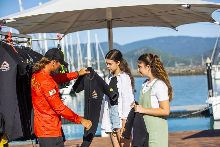 a couple of people that are standing in the snow