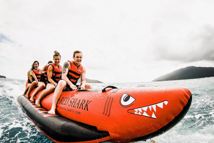 a group of people riding on the back of a boat