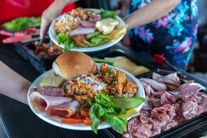 a group of people sitting at a table with a plate of food