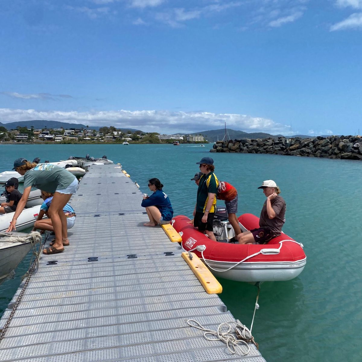 a group of people in a boat on a body of water