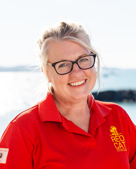 a person wearing glasses and smiling at the camera